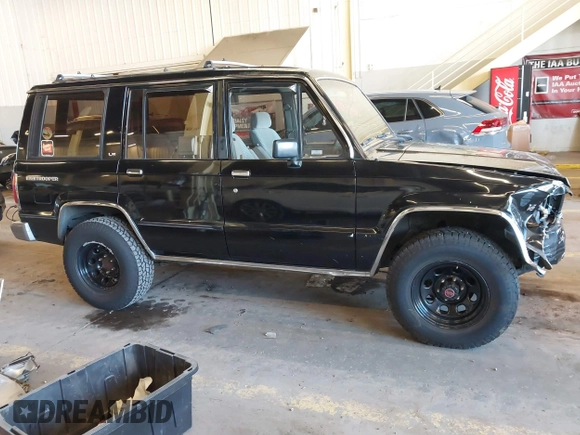 1991 Isuzu Trooper z VIN JACCH58R8M7902476, wystawiony jako IAAI lot #41893980 z przebiegiem 169 269 mil mil oraz . Historia ofert i sprzedaży dostępna na DreamBid. Obrazek 13.