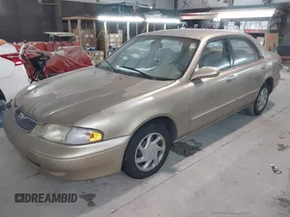 1999 Mazda 626 ES with VIN 1YVGF22C9X5823002, listed as a IAAI auction lot 41385617 with 149,127 mi miles. Bid and sale history available at carsss.com. Image 2.
