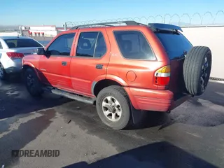 1999 Isuzu Rodeo S z VIN 4S2CK58W3X4307201, wystawiony jako IAAI lot #41884901 z przebiegiem 236 970 mil mil oraz . Historia ofert i sprzedaży dostępna na DreamBid. Obrazek 3.
