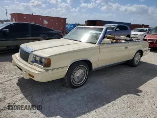 1986 Chrysler LeBaron z VIN 1C3BC55D0GG153072, wystawiony jako Copart lot #77865854 z przebiegiem 74 922 mil mil oraz Szkody całkowita. Historia ofert i sprzedaży dostępna na DreamBid. Obrazek 1.