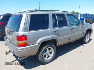 1998 Jeep Grand Cherokee Limited z VIN 1J4GZ88Z4WC328450, wystawiony jako IAAI lot #42652126 z przebiegiem 166 576 mil mil oraz . Historia ofert i sprzedaży dostępna na DreamBid. Obrazek 4.