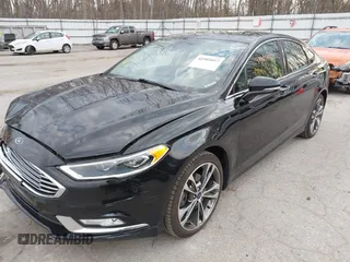2017 Ford Fusion Titanium z VIN 3FA6P0K98HR200272, wystawiony jako IAAI lot #41905017 z przebiegiem 104 132 mil mil oraz . Historia ofert i sprzedaży dostępna na DreamBid. Obrazek 2.