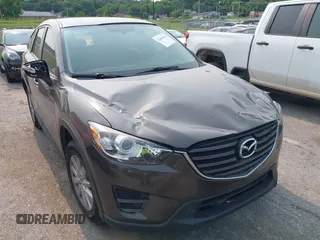 2016 Mazda CX-5 Sport with VIN JM3KE2BY1G0748511, listed as a IAAI auction lot 42401041 with 82,227 mi miles and . Bid and sale history available at DreamBid. Image 1.