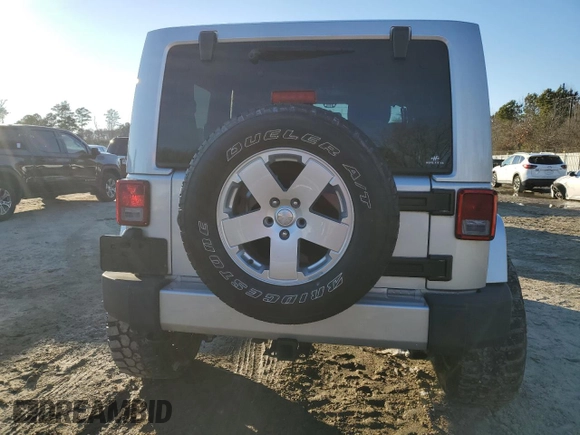 2011 Jeep Wrangler Sahara with VIN 1J4GA5D14BL628876, listed as a Copart auction lot 87317374 with 84,179 mi miles and Salvage Title. Bid and sale history available at DreamBid. Image 6.