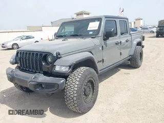 2021 Jeep Gladiator Sport S z VIN 1C6JJTAM1ML607525, wystawiony jako IAAI lot #41941550 z przebiegiem 59 283 mil mil oraz . Historia ofert i sprzedaży dostępna na DreamBid. Obrazek 2.