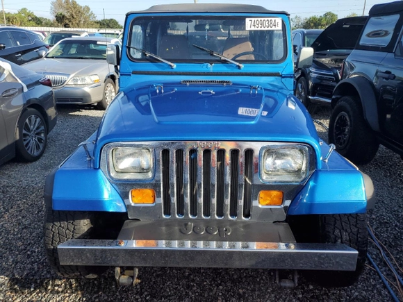 1992 Jeep Wrangler z VIN 2J4FY19P6NJ559597, wystawiony jako Copart lot #74990384 z przebiegiem 150 298 mil mil oraz Szkoda całkowita • Salvage title. Historia ofert i sprzedaży dostępna na DreamBid. Obrazek 5.