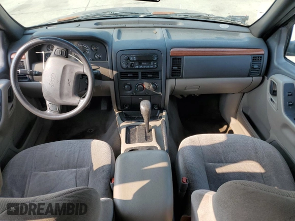 1999 Jeep Grand Cherokee Laredo with VIN 1J4G258S9XC731752, listed as a Copart auction lot 58601555 with 245,284 mi miles and Salvage title. Bid and sale history available at DreamBid. Image 8.