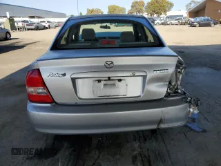 2002 Mazda Protege DX with VIN JM1BJ225120605237, listed as a Copart auction lot 49331225 with 184,556 mi miles and Salvage Title. Bid and sale history available at DreamBid. Image 6.