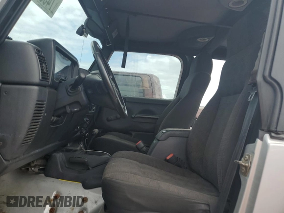 2003 Jeep Wrangler Rubicon z VIN 1J4FA69S53P340085, wystawiony jako Copart lot #74564574 z przebiegiem Nie podano mil oraz Szkoda całkowita • Salvage title. Historia ofert i sprzedaży dostępna na DreamBid. Obrazek 7.