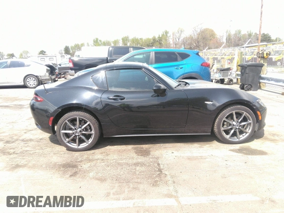2021 Mazda MX-5 Miata Grand Touring z VIN JM1NDAM75M0451597, wystawiony jako IAAI lot #41932712 z przebiegiem 61 710 mil mil oraz . Historia ofert i sprzedaży dostępna na DreamBid. Obrazek 13.