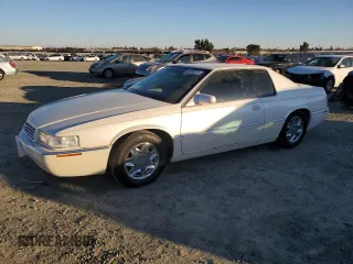 2002 Cadillac Eldorado z VIN 1G6EL12Y12B100821, wystawiony jako Copart lot #83495214 z przebiegiem 36 358 mil mil oraz Czysty tytuł • Clean title. Historia ofert i sprzedaży dostępna na DreamBid. Obrazek 1.