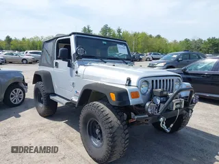 2003 Jeep Wrangler Sport z VIN 1J4FA49S73P302278, wystawiony jako IAAI lot #42219582 z przebiegiem 129 089 mil mil oraz . Historia ofert i sprzedaży dostępna na DreamBid. Obrazek 1.