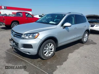 2014 Volkswagen Touareg Sport with VIN WVGEF9BP6ED007436, listed as a IAAI auction lot 41953307 with 114,925 mi miles and . Bid and sale history available at DreamBid. Image 2.