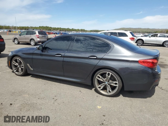 2018 BMW 5 Series M550i xDrive with VIN WBAJB9C57JB286734, listed as a Copart auction lot 52711235 with 127,450 mi miles and Salvage title. Bid and sale history available at DreamBid. Image 2.
