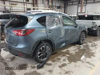 2016 Mazda CX-5 Grand Touring z VIN JM3KE4DY9G0714468, wystawiony jako IAAI lot #41860956 z przebiegiem 114 481 mil mil oraz . Historia ofert i sprzedaży dostępna na DreamBid. Obrazek 4.