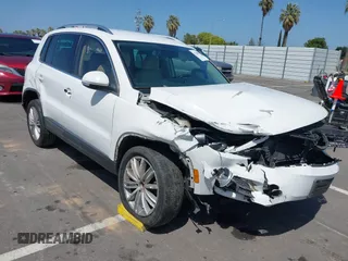 2014 Volkswagen Tiguan SEL with VIN WVGAV3AX9EW512956, listed as a IAAI auction lot 42110002 with 136,034 mi miles and . Bid and sale history available at DreamBid. Image 1.