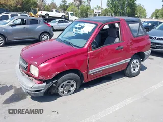 1999 Chevrolet Tracker z VIN 2CNBJ1865X6935435, wystawiony jako IAAI lot #42421108 z przebiegiem Nie podano mil oraz . Historia ofert i sprzedaży dostępna na DreamBid. Obrazek 2.