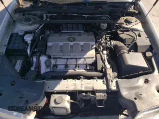 1999 Cadillac Eldorado z VIN 1G6EL12Y0XU604529, wystawiony jako Copart lot #77620004 z przebiegiem 246 032 mil mil oraz Szkoda całkowita • Salvage title. Historia ofert i sprzedaży dostępna na DreamBid. Obrazek 11.