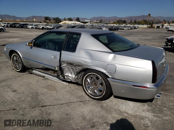 1999 Cadillac Eldorado z VIN 1G6EL12Y0XU604529, wystawiony jako Copart lot #77620004 z przebiegiem 246 032 mil mil oraz Szkoda całkowita • Salvage title. Historia ofert i sprzedaży dostępna na DreamBid. Obrazek 2.