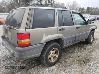 1996 Jeep Grand Cherokee Laredo with VIN 1J4FX58S5TC248122, listed as a Copart auction lot 45843935 with 295,521 mi miles and Salvage Title. Bid and sale history available at carsss.com. Image 3.