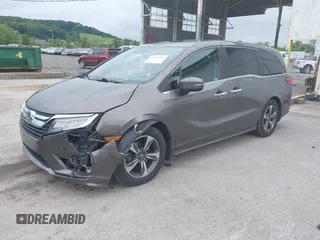 2018 Honda Odyssey Touring with VIN 5FNRL6H89JB057148, listed as a IAAI auction lot 42511909 with 166,438 mi miles and . Bid and sale history available at DreamBid. Image 2.