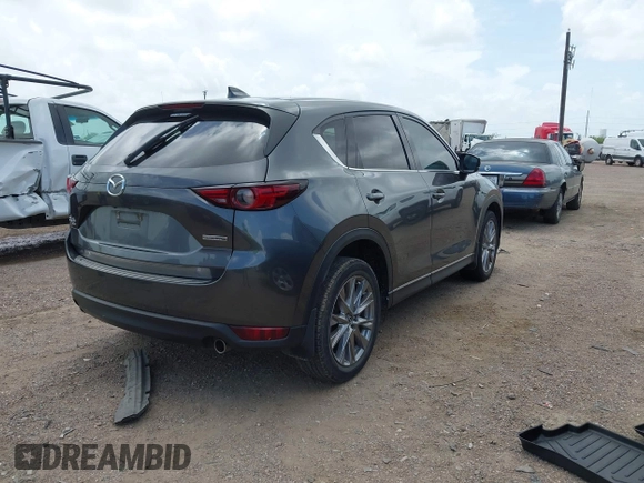 2021 Mazda CX-5 Grand Touring with VIN JM3KFBDM2M0431484, listed as a IAAI auction lot 42547665 with 34,757 mi miles and . Bid and sale history available at DreamBid. Image 4.