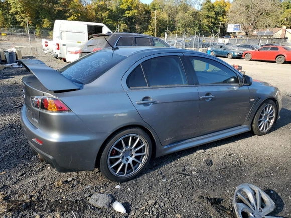 2014 Mitsubishi Lancer Evolution GSR z VIN JA32W8FV6EU018171, wystawiony jako Copart lot #77109934 z przebiegiem 83 467 mil mil oraz Tytuł czysty. Historia ofert i sprzedaży dostępna na DreamBid. Obrazek 3.