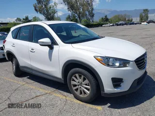 2016 Mazda CX-5 Sport z VIN JM3KE2BY5G0793032, wystawiony jako IAAI lot #42128706 z przebiegiem 52 010 mil mil oraz . Historia ofert i sprzedaży dostępna na DreamBid. Obrazek 1.