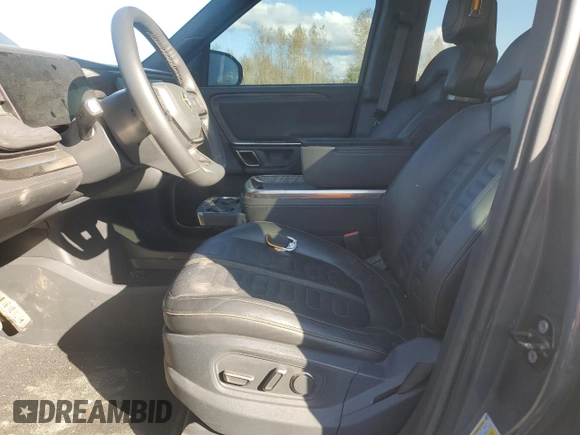 2022 Rivian R1S Launch Edition with VIN 7PDSGABL1NN000514, listed as a Copart auction lot 77444184 with 29,490 mi miles and Salvage Title. Bid and sale history available at DreamBid. Image 7.