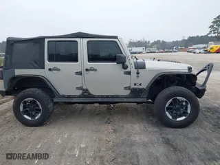 2007 Jeep Wrangler Unlimited X with VIN 1J4GA391X7L107424, listed as a IAAI auction lot 41752013 with 196,557 mi miles. Bid and sale history available at carsss.com. Image 13.