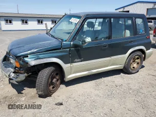1998 Suzuki Sidekick z VIN JS3TD21V9W4103914, wystawiony jako Copart lot #62112514 z przebiegiem 394 872 mil mil oraz Szkody całkowita. Historia ofert i sprzedaży dostępna na DreamBid. Obrazek 1.