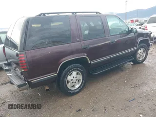 1997 GMC Yukon with VIN 1GKEK13R0VJ755574, listed as a IAAI auction lot 41158932 with 212,668 mi miles. Bid and sale history available at carsss.com. Image 4.