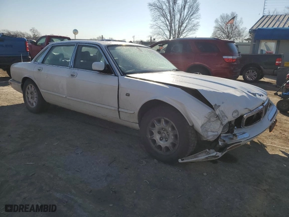 2001 Jaguar XJ with VIN SAJDA14CX1LF29825, listed as a Copart auction lot 42064715 with 127,389 mi miles and Salvage Title. Bid and sale history available at carsss.com. Image 4.
