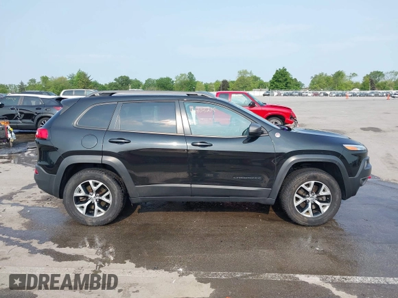 2015 Jeep Cherokee Trailhawk with VIN 1C4PJMBS6FW786622, listed as a IAAI auction lot 42403215 with 148,205 mi miles and . Bid and sale history available at DreamBid. Image 13.