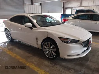2021 Mazda 6 Carbon Edition with VIN JM1GL1WY9M1614117, listed as a IAAI auction lot 41305576 with 54,670 mi miles and . Bid and sale history available at DreamBid. Image 1.
