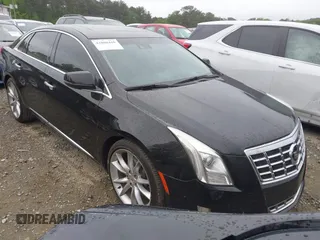 2014 Cadillac XTS Premium z VIN 2G61P5S39E9193527, wystawiony jako IAAI lot #42080410 z przebiegiem 116 966 mil mil oraz . Historia ofert i sprzedaży dostępna na DreamBid. Obrazek 1.