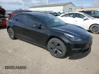 2021 Tesla Model 3 Standard Range Plus with VIN 5YJ3E1EA7MF053663, listed as a Copart auction lot 51982265 with 90,529 mi miles and Salvage Title. Bid and sale history available at DreamBid. Image 4.