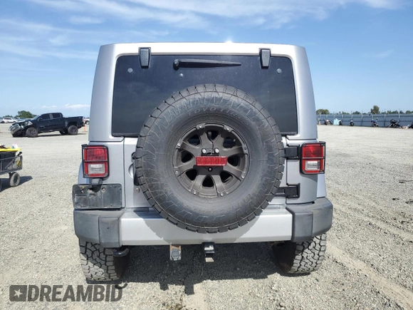 2014 Jeep Wrangler Unlimited Sahara with VIN 1C4HJWEG1EL126611, listed as a Copart auction lot 57169485 with 122,000 mi miles and Salvage title. Bid and sale history available at DreamBid. Image 6.