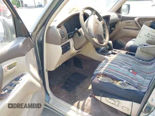1999 Toyota Land Cruiser z VIN JT3HT05JXX0060572, wystawiony jako IAAI lot #42489190 z przebiegiem 253 014 mil mil oraz . Historia ofert i sprzedaży dostępna na DreamBid. Obrazek 5.