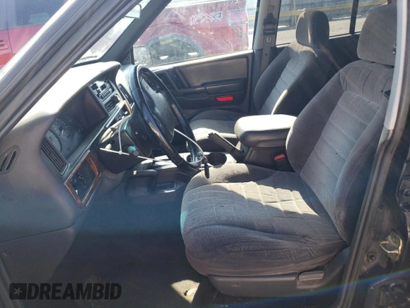 1998 Jeep Grand Cherokee Laredo with VIN 1J4GZ58S8WC167716, listed as a Copart auction lot 76477694 with 167,519 mi miles and Salvage Title. Bid and sale history available at carsss.com. Image 7.