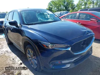 2020 Mazda CX-5 Grand Touring with VIN JM3KFBDM7L1801241, listed as a IAAI auction lot 42583264 with 98,029 mi miles and . Bid and sale history available at DreamBid. Image 1.