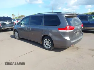 2014 Toyota Sienna XLE with VIN 5TDYK3DC2ES438980, listed as a IAAI auction lot 42067750 with 143,728 mi miles and . Bid and sale history available at DreamBid. Image 3.