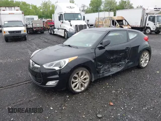 2012 Hyundai Veloster w/Gray Int z VIN KMHTC6AD0CU080630, wystawiony jako IAAI lot #42191015 z przebiegiem 48 405 mil mil oraz . Historia ofert i sprzedaży dostępna na DreamBid. Obrazek 2.