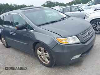2011 Honda Odyssey Touring with VIN 5FNRL5H91BB033009, listed as a IAAI auction lot 42550524 with 247,785 mi miles and . Bid and sale history available at DreamBid. Image 1.