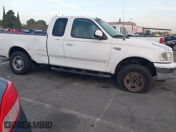 1999 Ford F-150 XL with VIN 1FTRX18L1XKB61205, listed as a IAAI auction lot 40991236 with 178,889 mi miles. Bid and sale history available at carsss.com. Image 13.