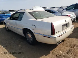 2000 Cadillac Eldorado z VIN 1G6EL12Y2YU179560, wystawiony jako Copart lot #70635784 z przebiegiem 92 959 mil mil oraz Tytuł czysty. Historia ofert i sprzedaży dostępna na DreamBid. Obrazek 2.