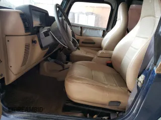 2000 Jeep Wrangler SE with VIN 1J4FA29P1YP739555, listed as a Copart auction lot 58501025 with 128,458 mi miles and Clean title. Bid and sale history available at DreamBid. Image 7.