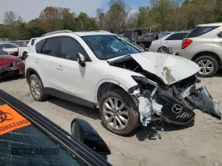 2015 Mazda CX-5 Grand Touring with VIN JM3KE4DY0F0458719, listed as a Copart auction lot 52960365 with 128,372 mi miles and Salvage Title. Bid and sale history available at DreamBid. Image 4.