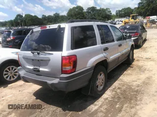 2004 Jeep Grand Cherokee Laredo z VIN 1J4GW48SX4C309998, wystawiony jako IAAI lot #42307167 z przebiegiem 306 912 mil mil oraz . Historia ofert i sprzedaży dostępna na DreamBid. Obrazek 4.