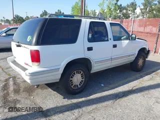 1996 GMC Jimmy SL with VIN 1GKDT13W4T2546327, listed as a IAAI auction lot 41966572 with 134,749 mi miles. Bid and sale history available at carsss.com. Image 4.